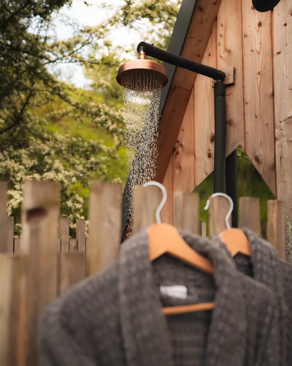 Robes hanging by the outdoor shower