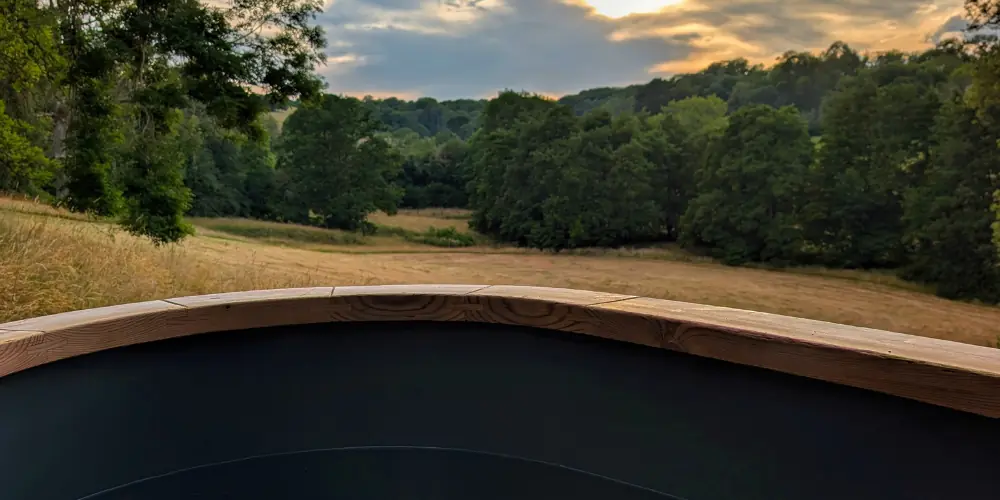 Wooden hot tub on the A Frame deck at sunset