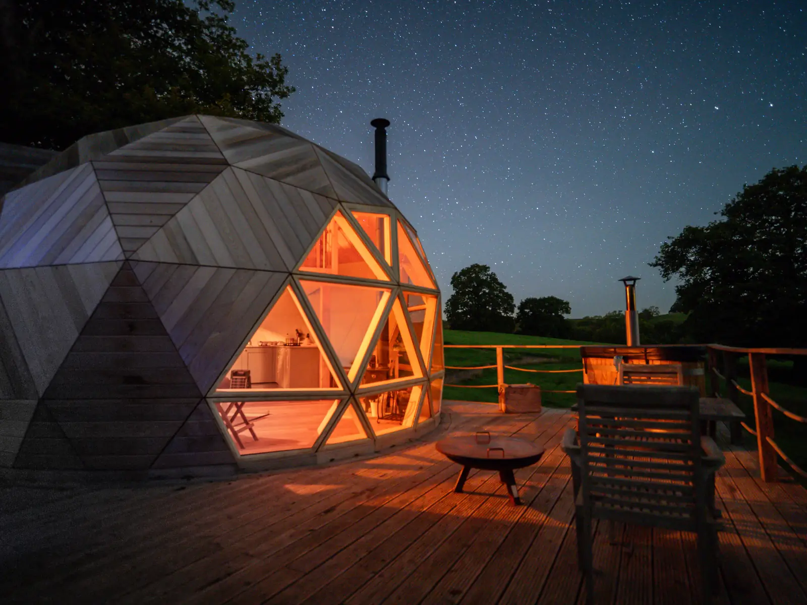 The Nova Dome glowing at night under a starry sky