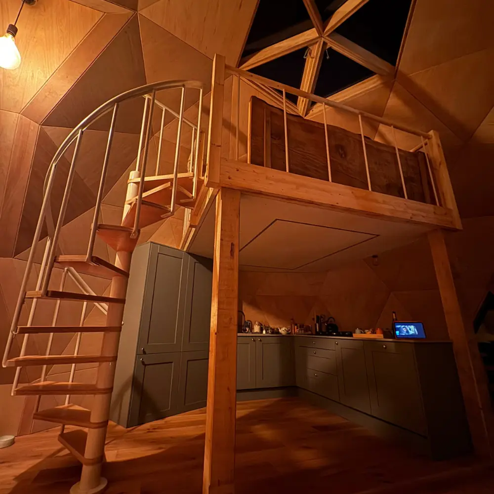 Spiral stairs up to the mezzanine bed inside the dome