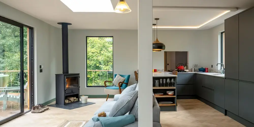 Open-plan living room and kitchen with a wood burner