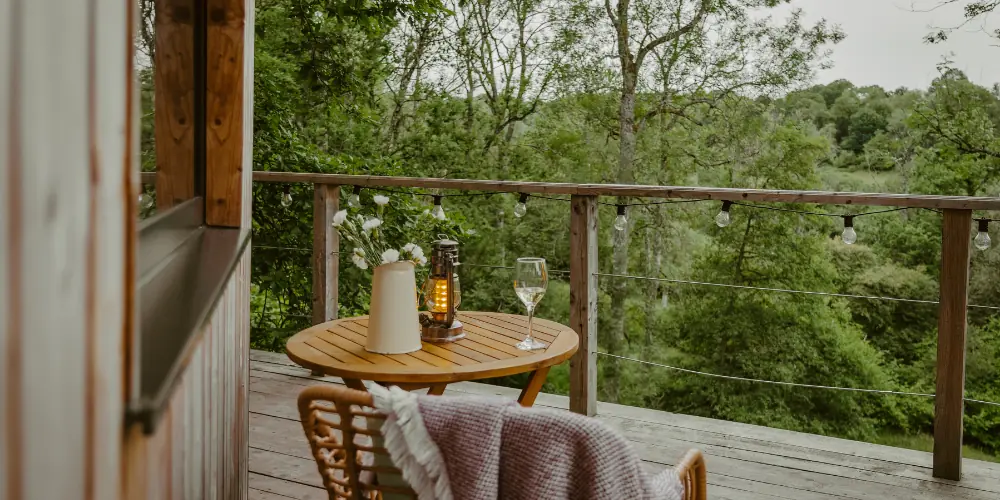 Bistro table and chairs on the Treehouse deck looking over the trees